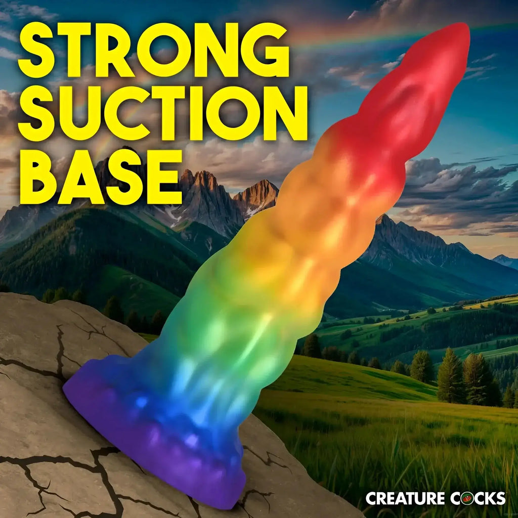 Rainbow-colored glossy silicone dildo with textured suction base from Creature Cocks Magic Rider Unicorn collection