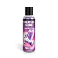A clear plastic bottle with black cap contains purple creature slime water based lubricant by Creature Cocks