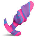 A vibrant pink and purple swirl silicone medium anal plug with a curved tail from creature cocks unicorn swirl collection