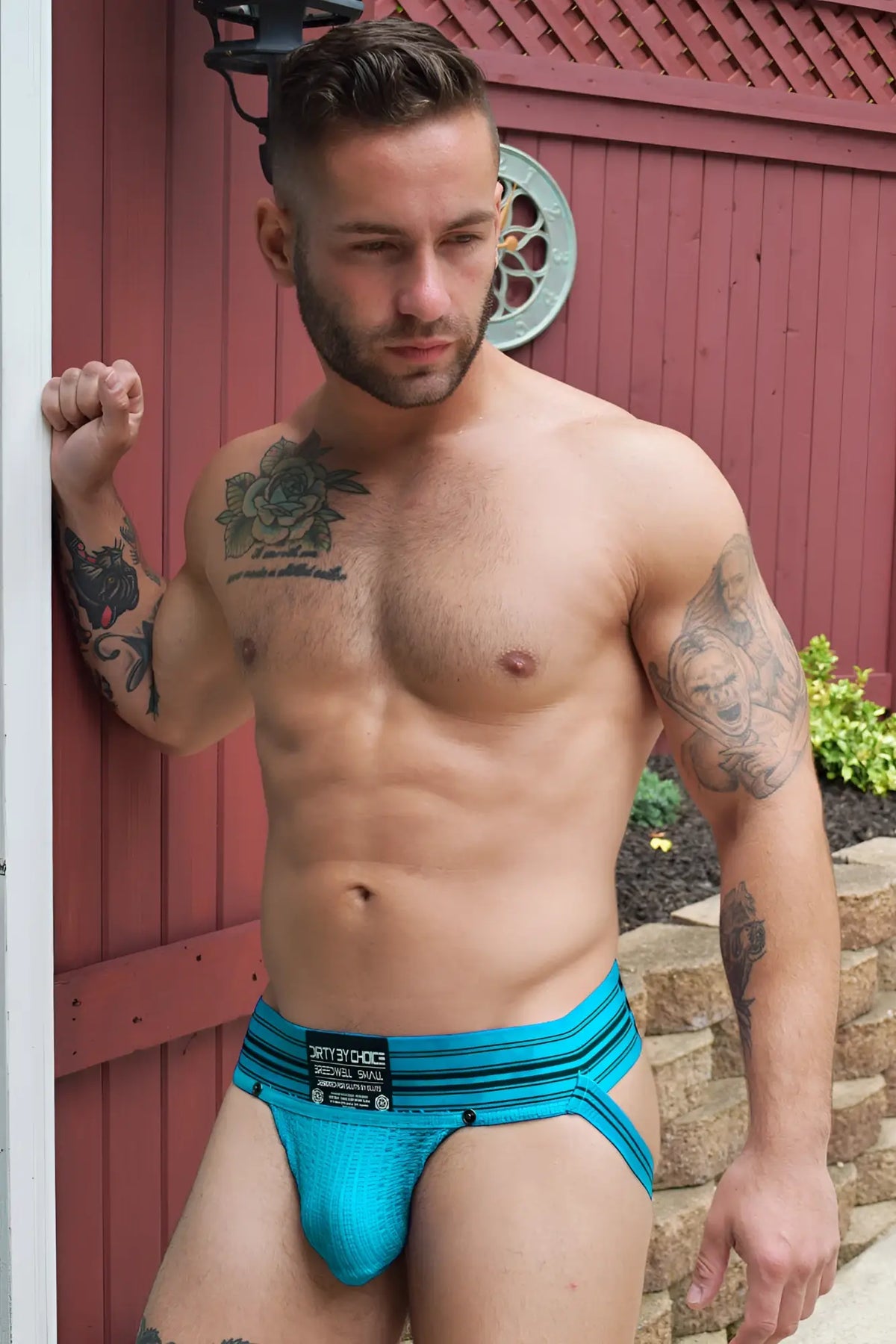 Bright turquoise blue cumdump jock athletic briefs with black trim and branded waistband label in aqua blue color
