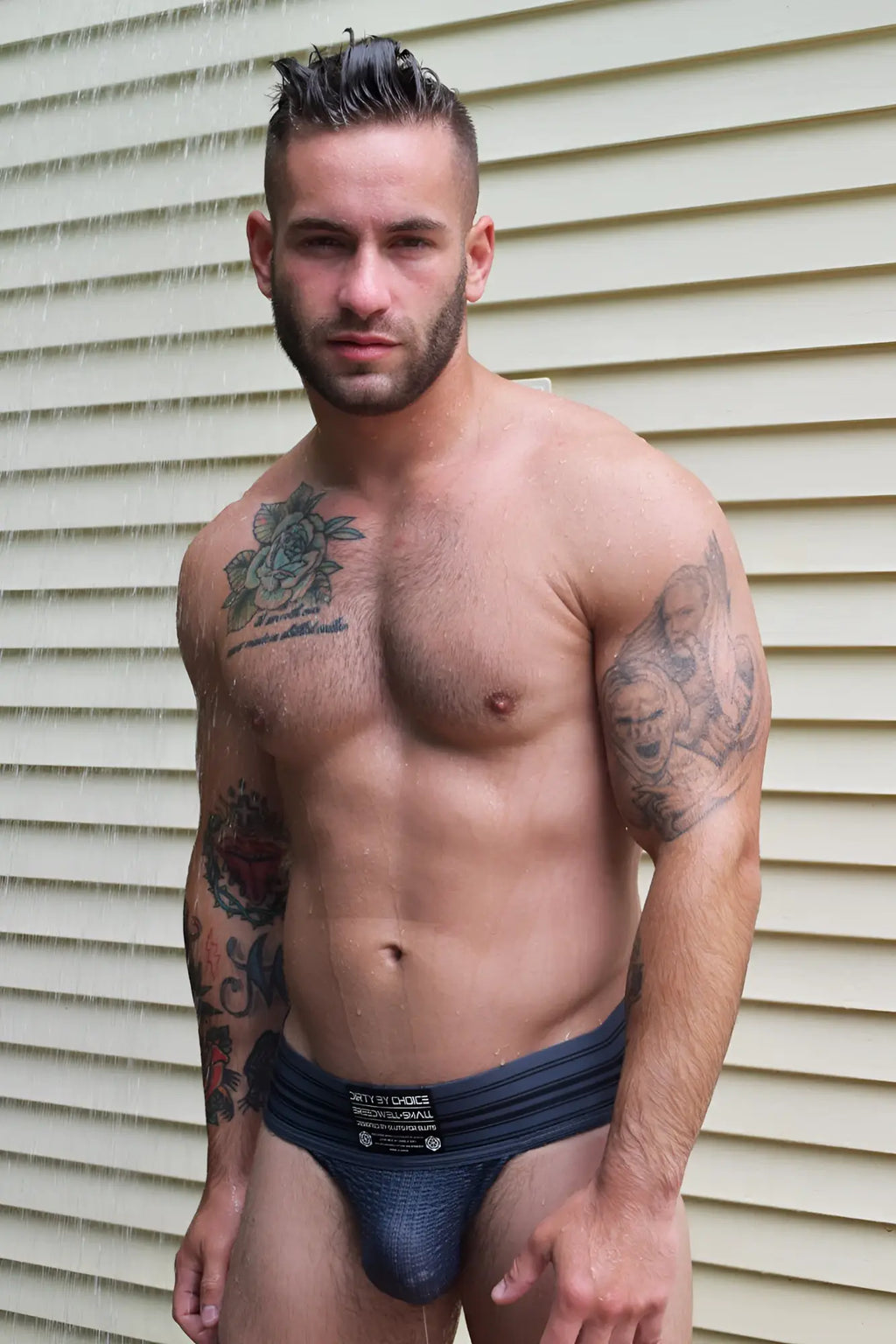 Dark blue athletic briefs with black label featuring white text and logo in cumdump jock grey product line
