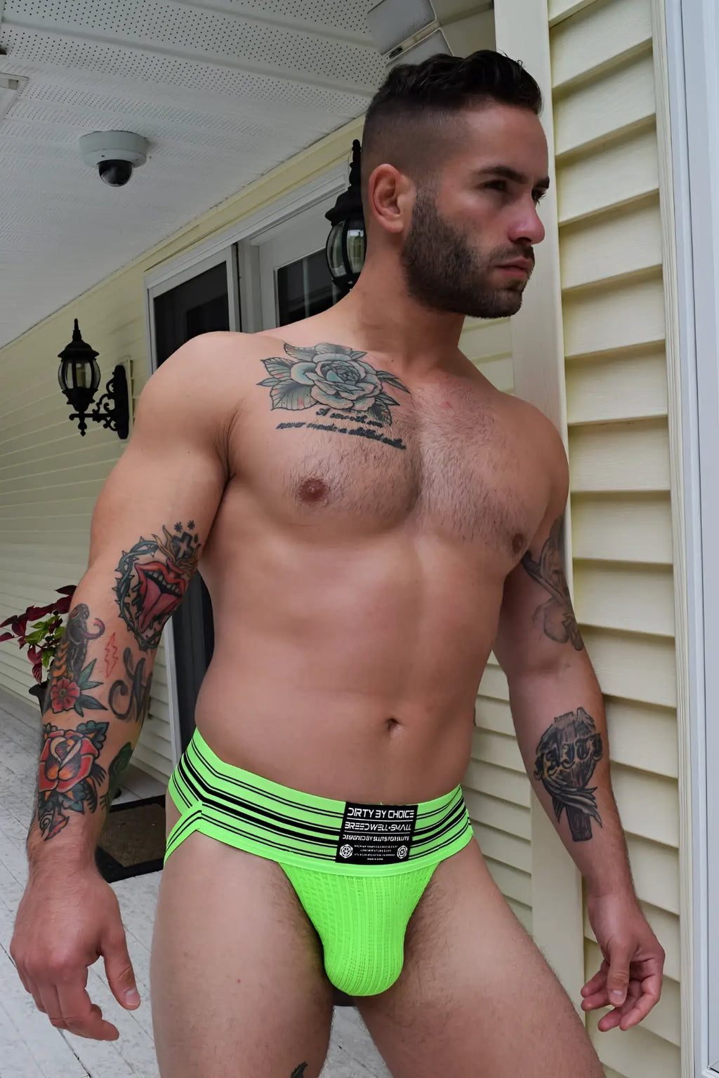 Bright neon green cumdump jock athletic briefs with black horizontal stripes and branded waistband label
