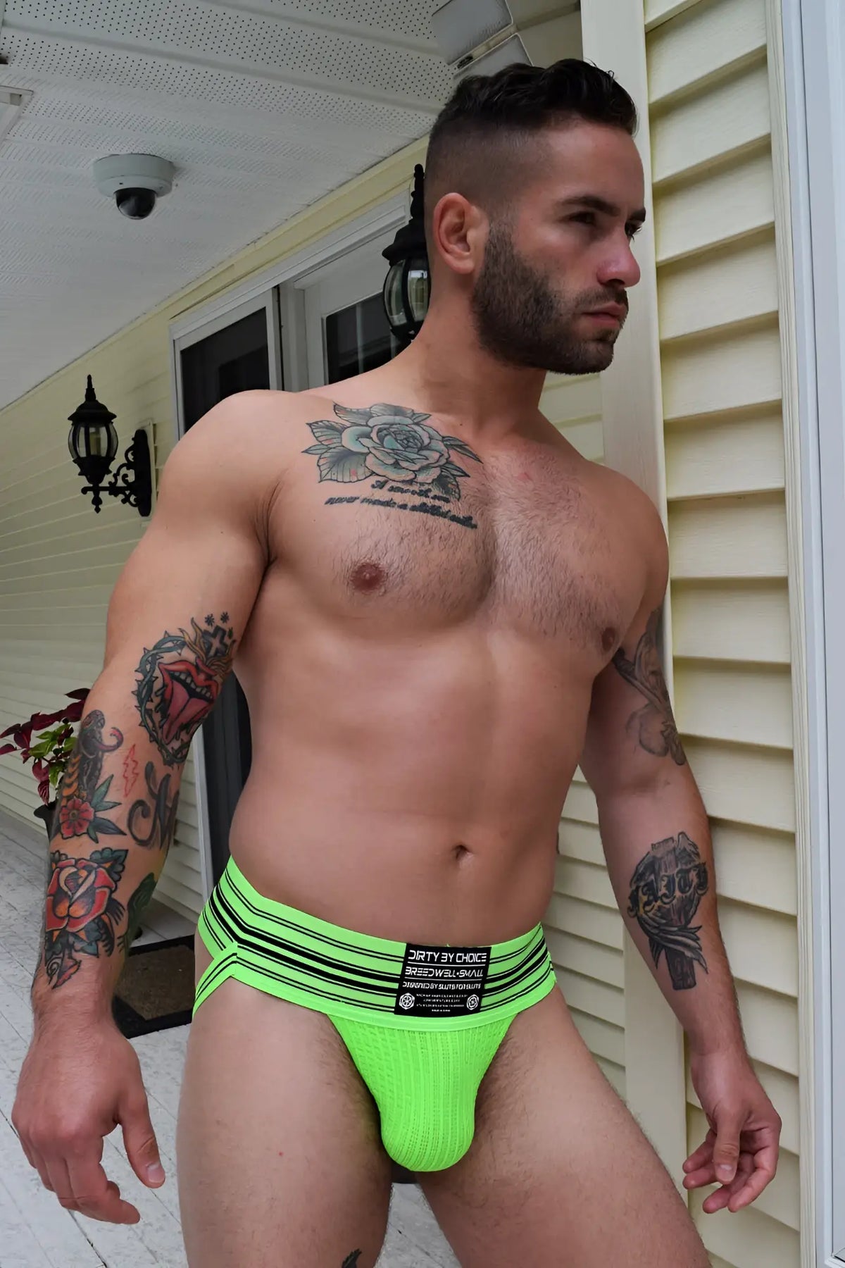 Bright neon green cumdump jock athletic briefs with black horizontal stripes and branded waistband label