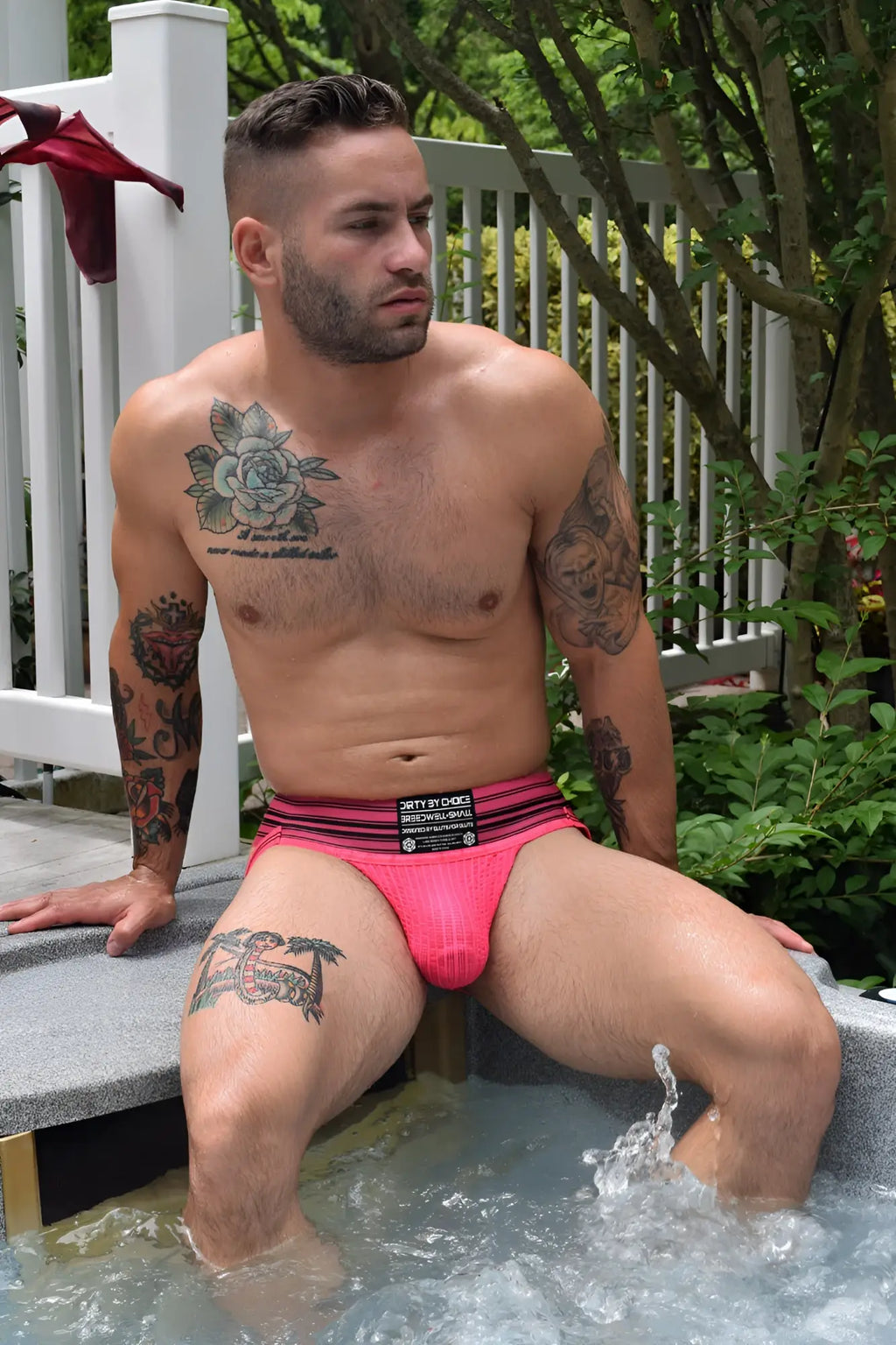 Bright pink textured cumdump jock briefs with black and white branding stripes in neon pink color