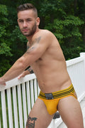 Yellow striped briefs with black trim and a branded waistband label from the Cumdump Jock collection