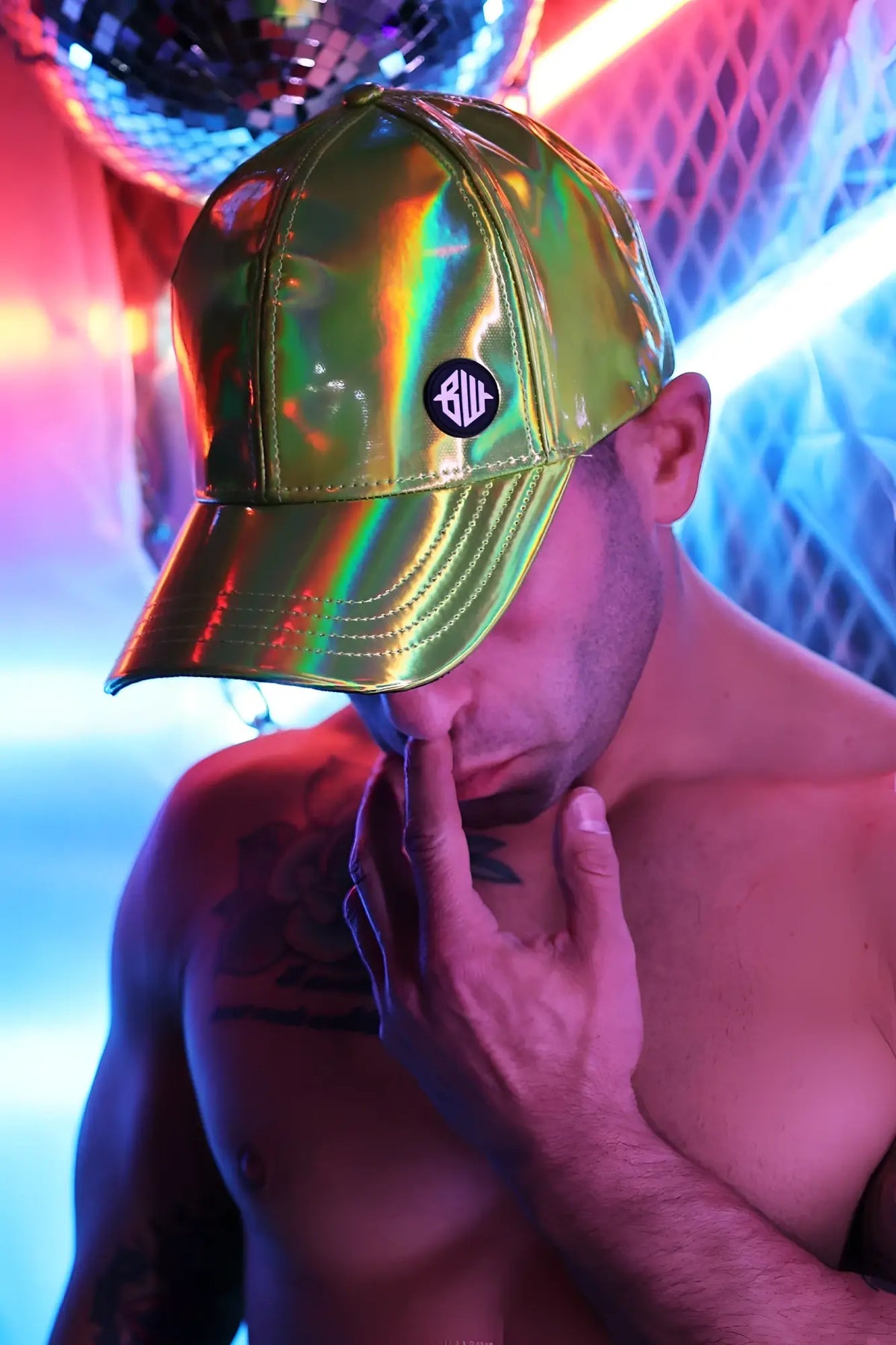 A shiny iridescent green holographic baseball cap with a black circular logo front called cyber holo hat lime