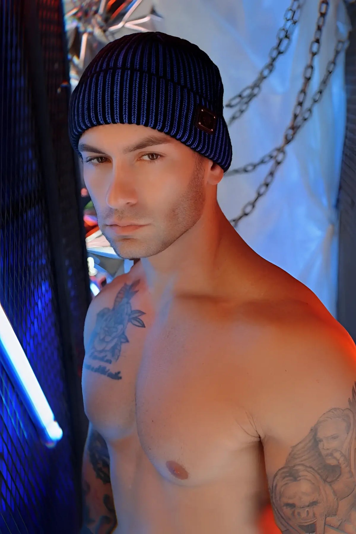 Blue ribbed knit darkroom rib beanie with a small dark rectangular patch on the front for cold weather wear