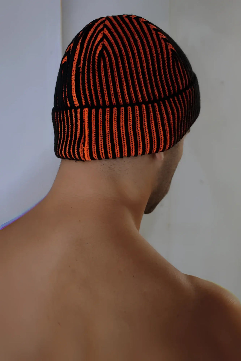 Darkroom rib beanie knitted with bold orange and black vertical stripes and a ribbed brim for warmth and style