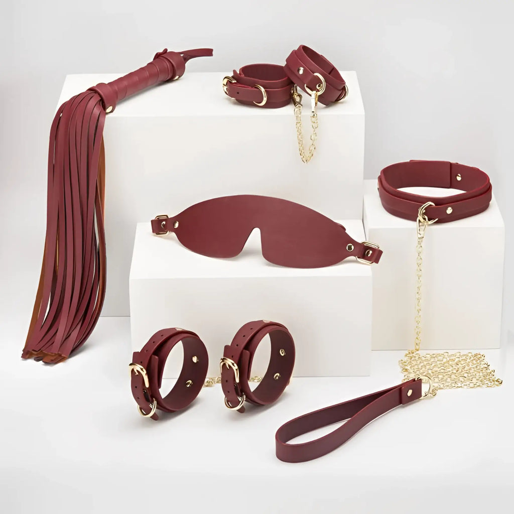 Daytona 8 pc deluxe bondage play kit in burgundy leather with gold-tone metal hardware for intimate use