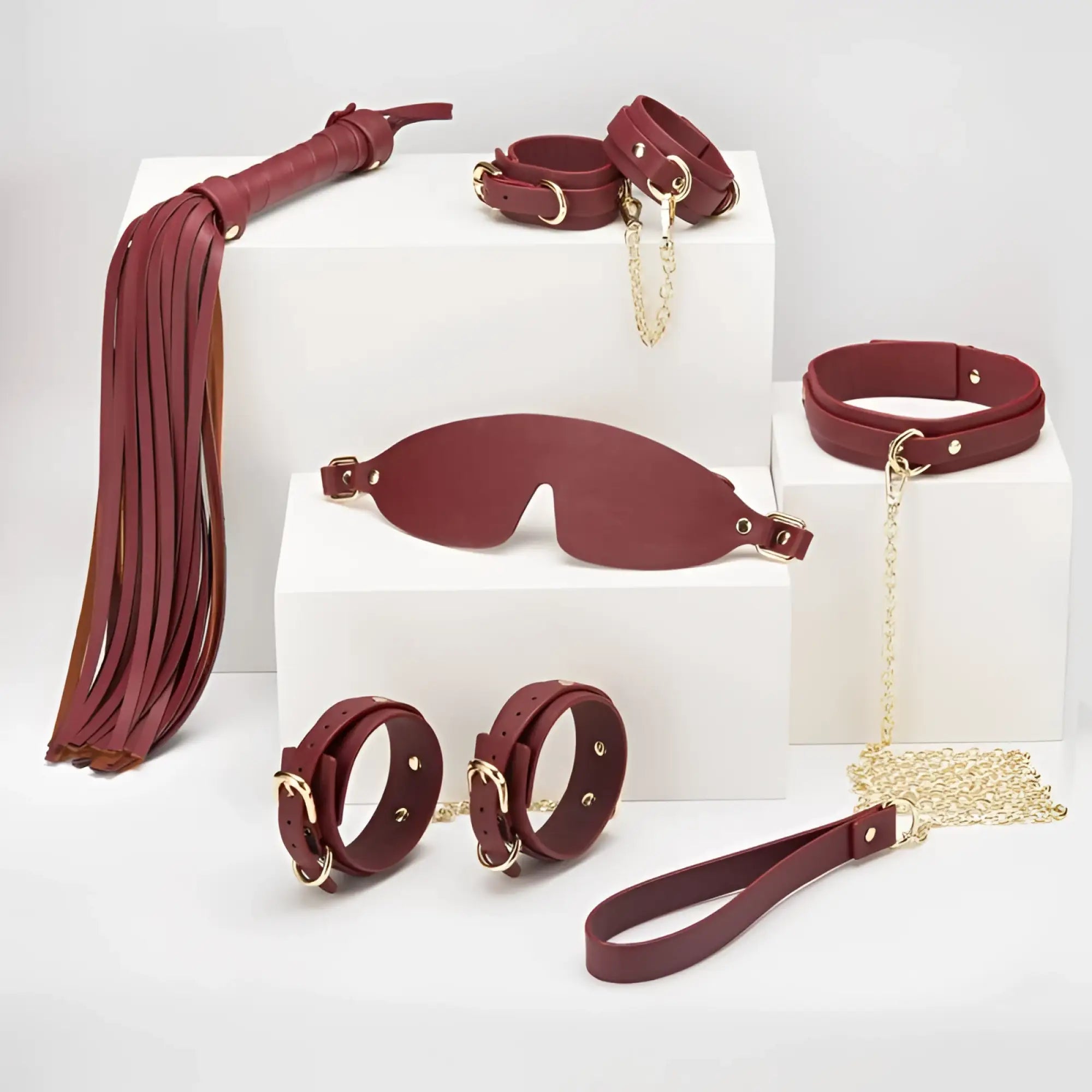 Daytona 8 pc deluxe bondage play kit in burgundy leather with gold-tone metal hardware for intimate use