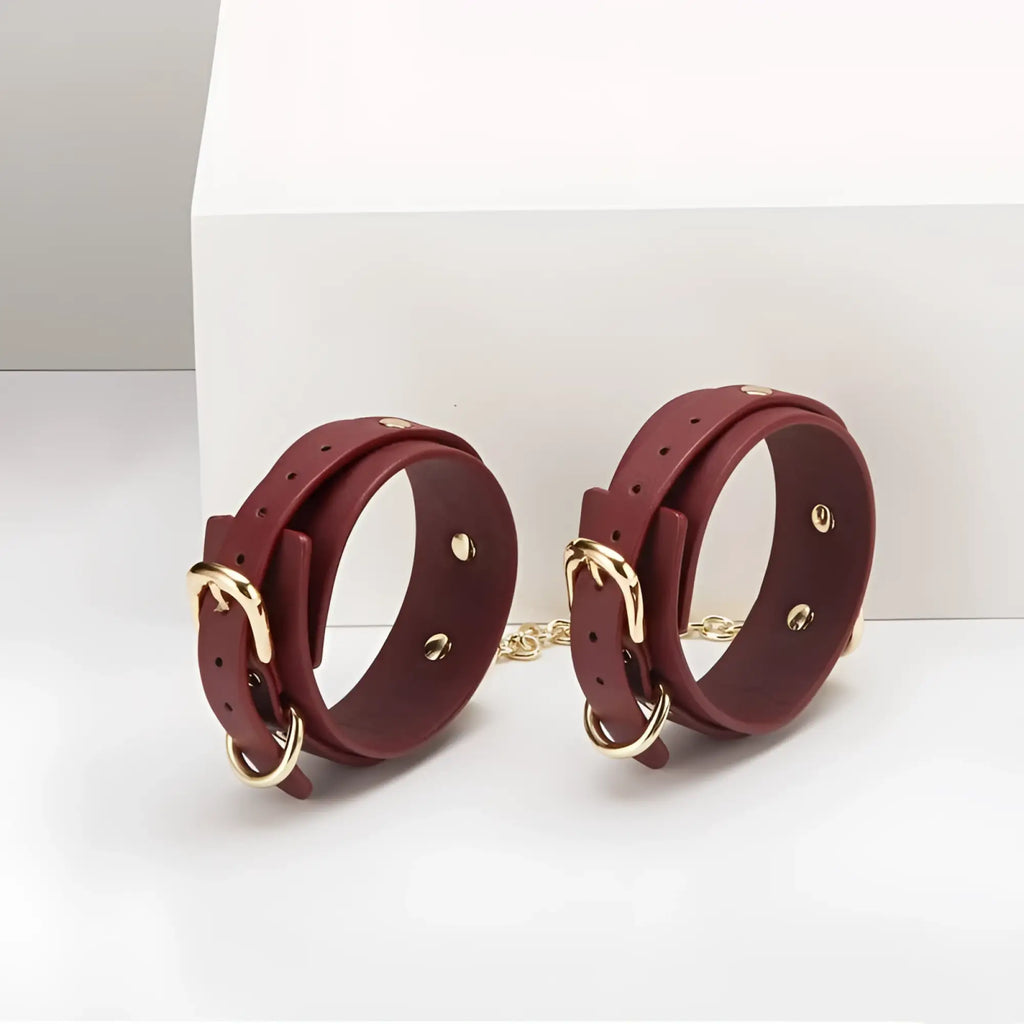 Daytona 8 pc deluxe bondage play kit featuring burgundy leather wrist cuffs with gold-tone buckles and connecting chain