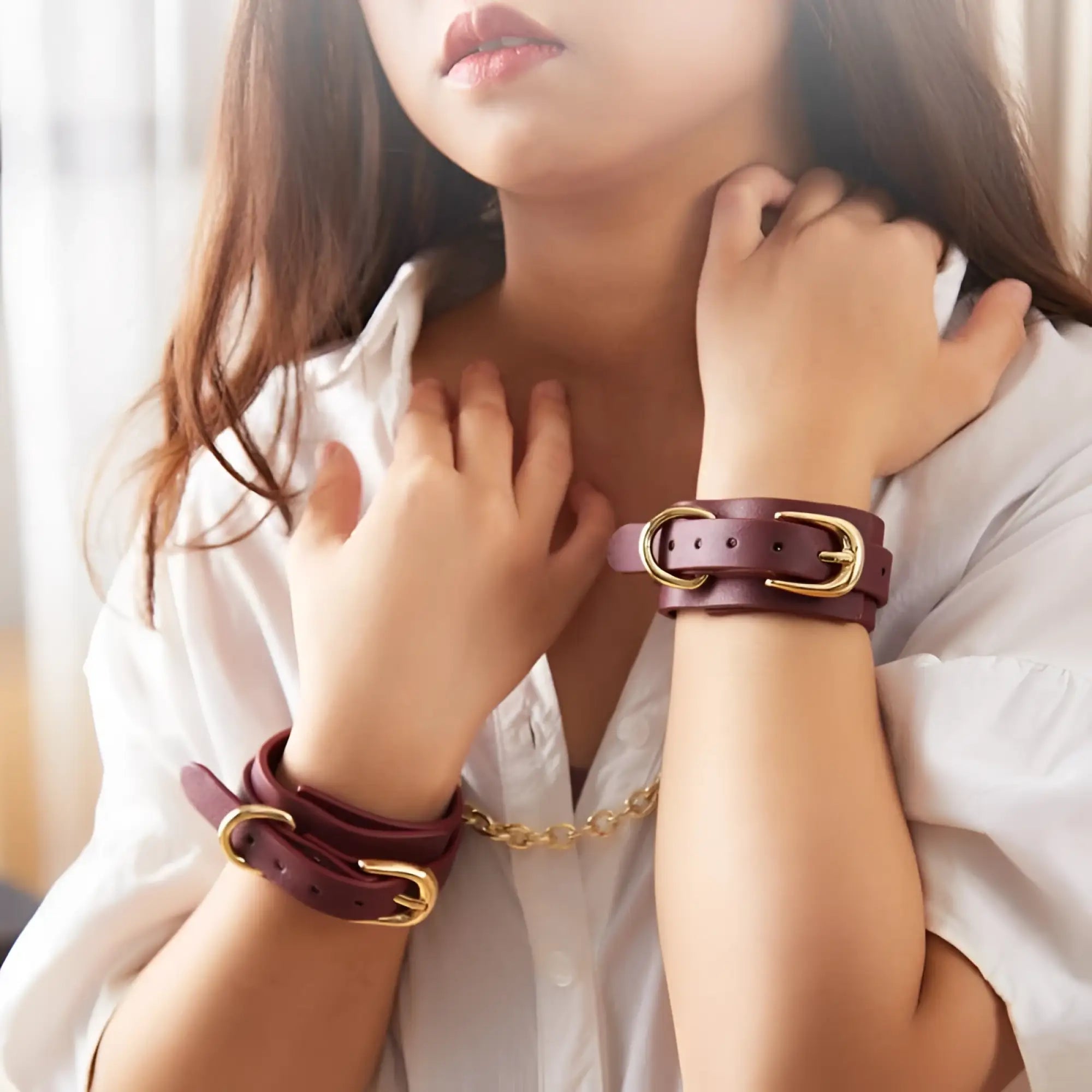 Burgundy leather wrist cuffs with gold-toned buckles and chain from Daytona 8 Pc Deluxe Bondage Play Kit