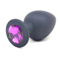 Daytona black silicone anal plug large with a sleek matte finish and faceted purple gemstone on the rounded head