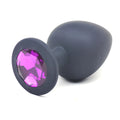 Daytona black silicone anal plug large with a sleek matte finish and faceted purple gemstone on the rounded head