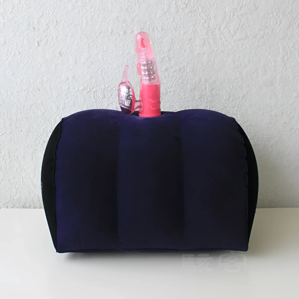 Navy blue inflatable half dome cushion with black trim and two pink vibrating toys in toy holders for positioning