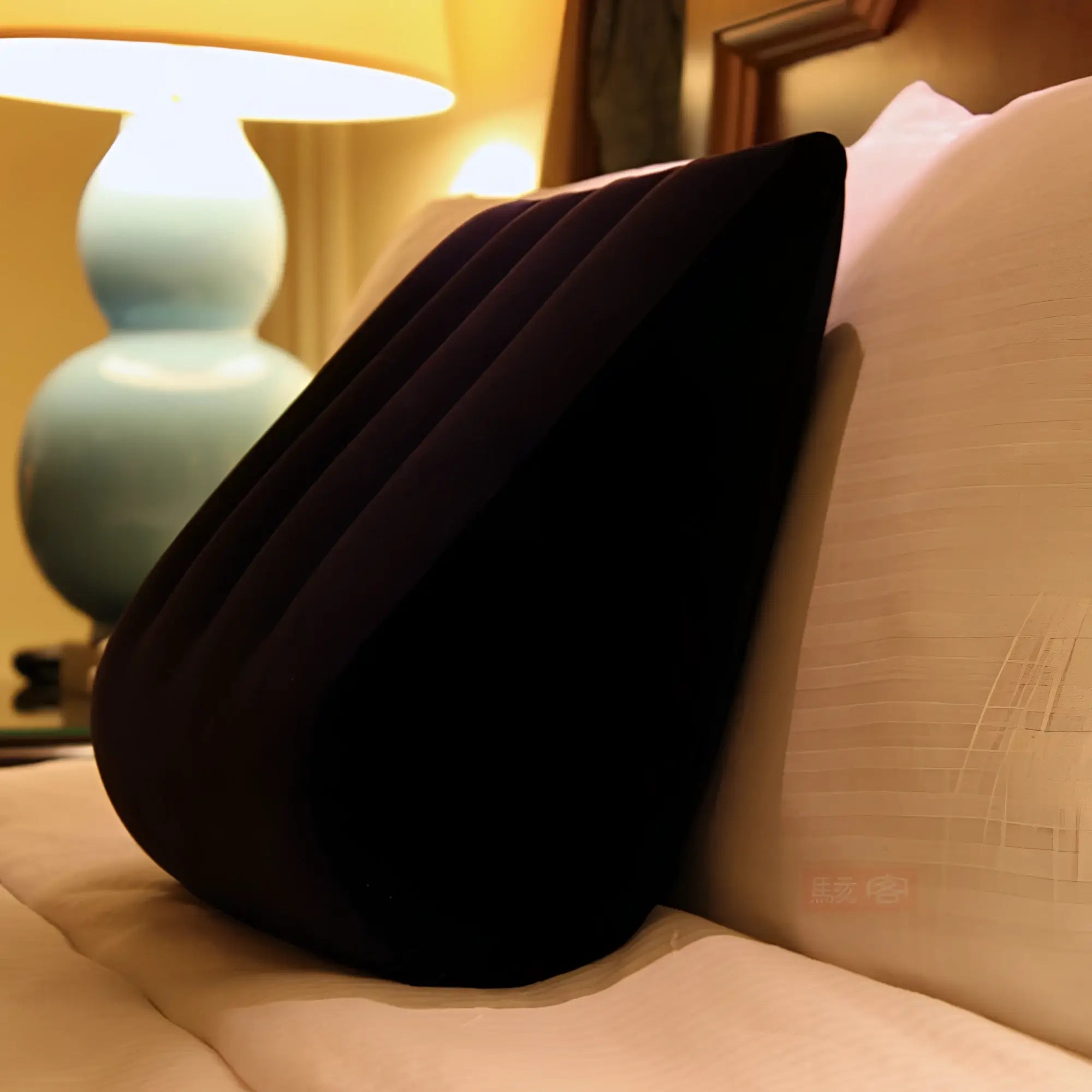 Black inflatable wedge pillow with ribbed texture for sex positioning in the daytona triangular cushion design