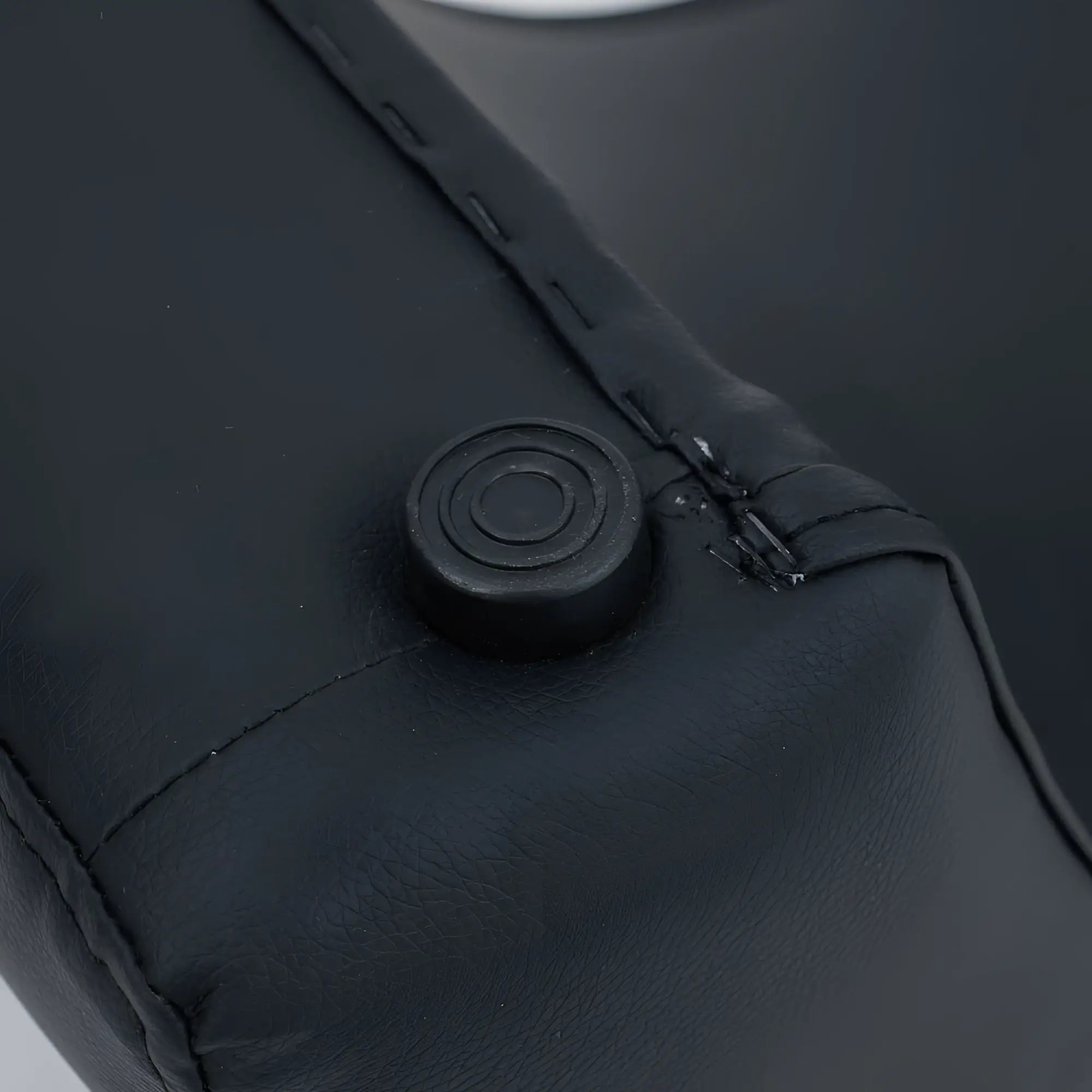 Black faux leather zipper pull with circular textured design on daytona kama sutra halo arc love lounge black product