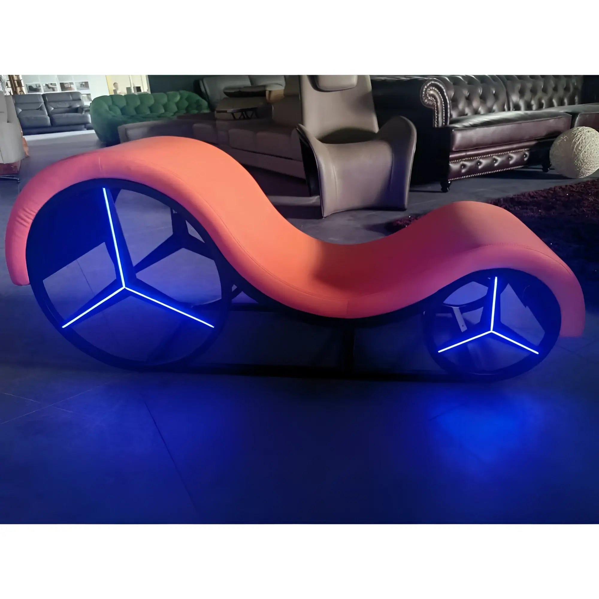 A sleek coral-daytona kama sutra mebon chaise love lounge with metal frame and blue led wheel base lights
