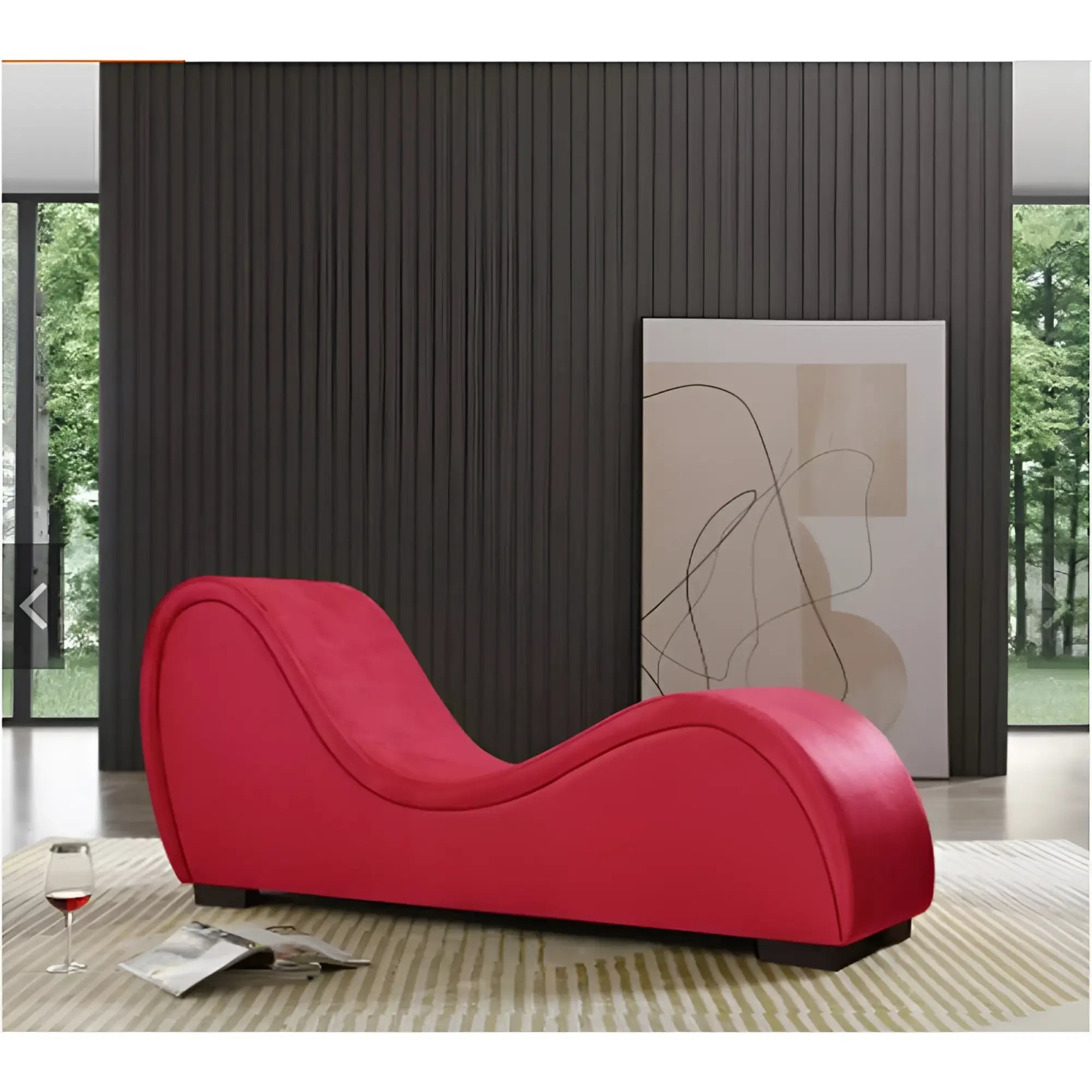 A vibrant red Daytona Kama Sutra Mebon chaise love lounge with sleek curves upholstered in smooth fabric