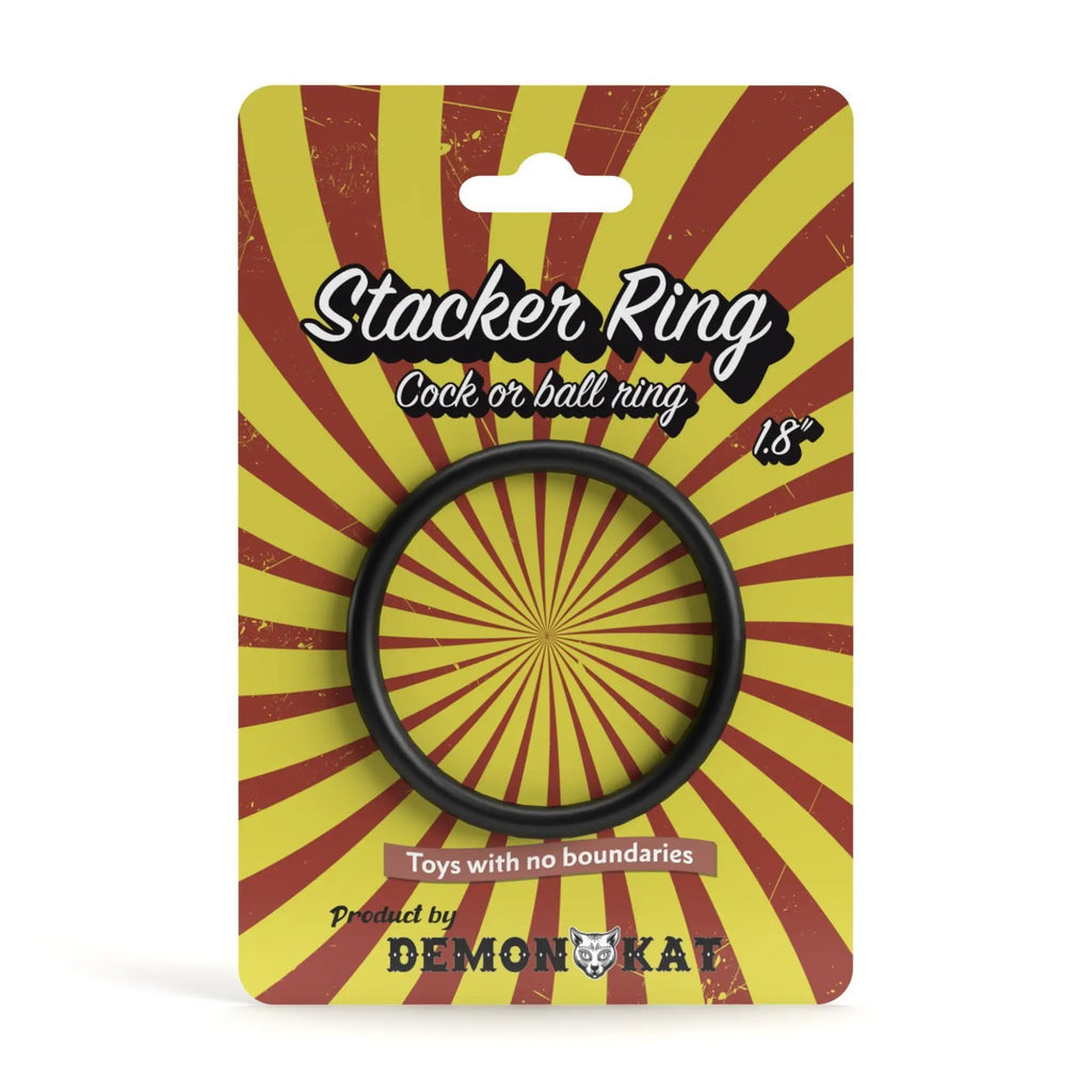 Black silicone demon kat stacker ring 1.8 inch diameter on yellow and red sunburst packaging card