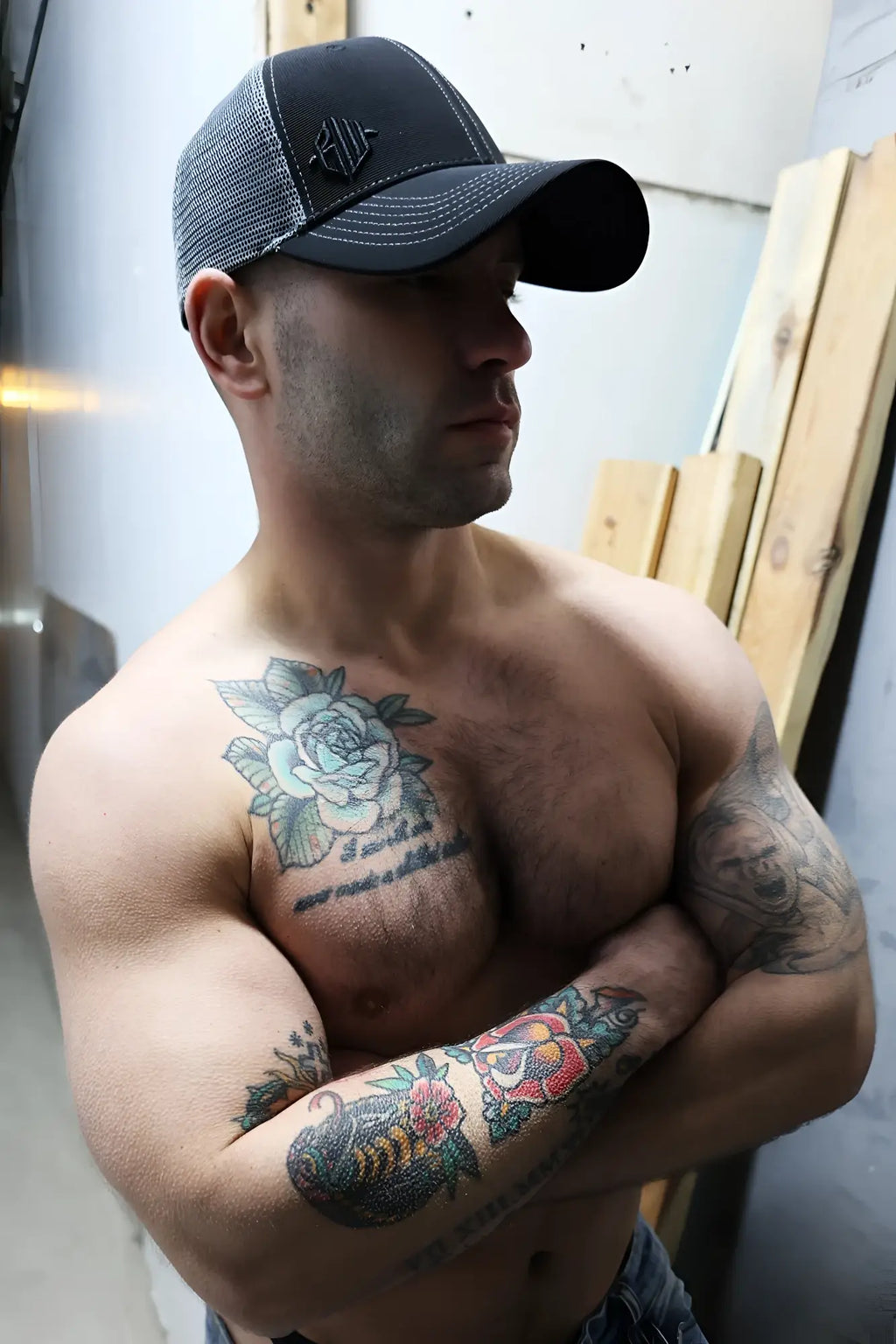 Black and gray mesh dirty trucker hat with a small embroidered logo on the front