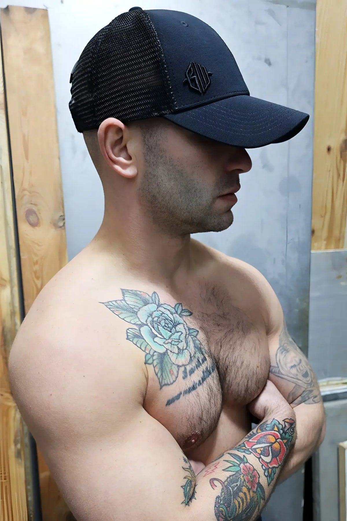 Black trucker hat with mesh back and small embroidered logo featured in the Dirty Trucker Hat product line