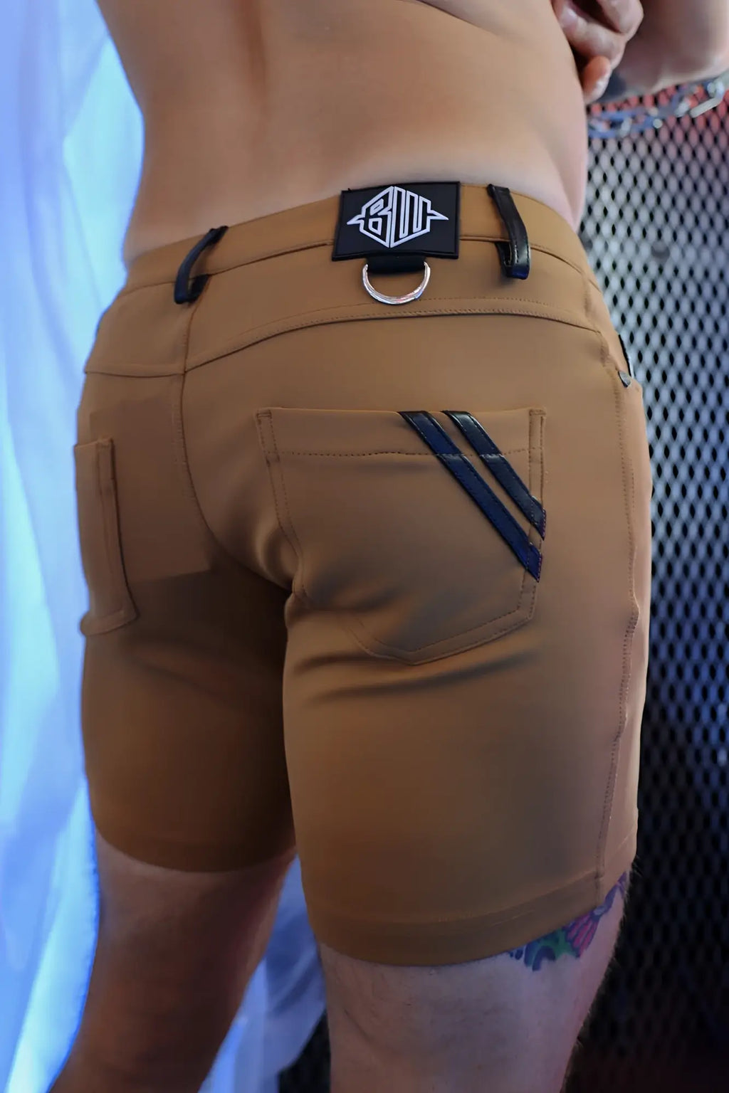 Down low shorts dark khaki in tan with black leather-like straps and black logo patch on the waistband