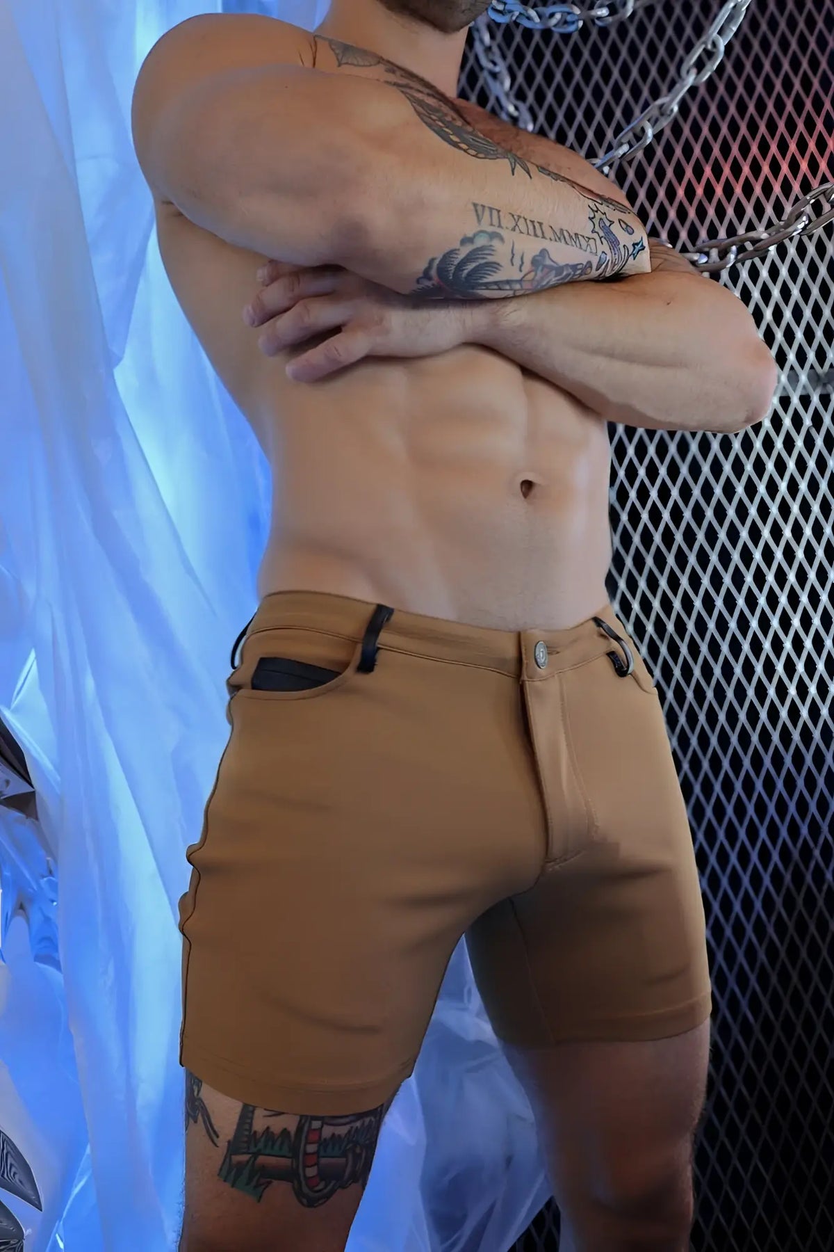 Tan dark khaki down low cargo shorts with black fabric accents on side pockets and belt loops for casual wear