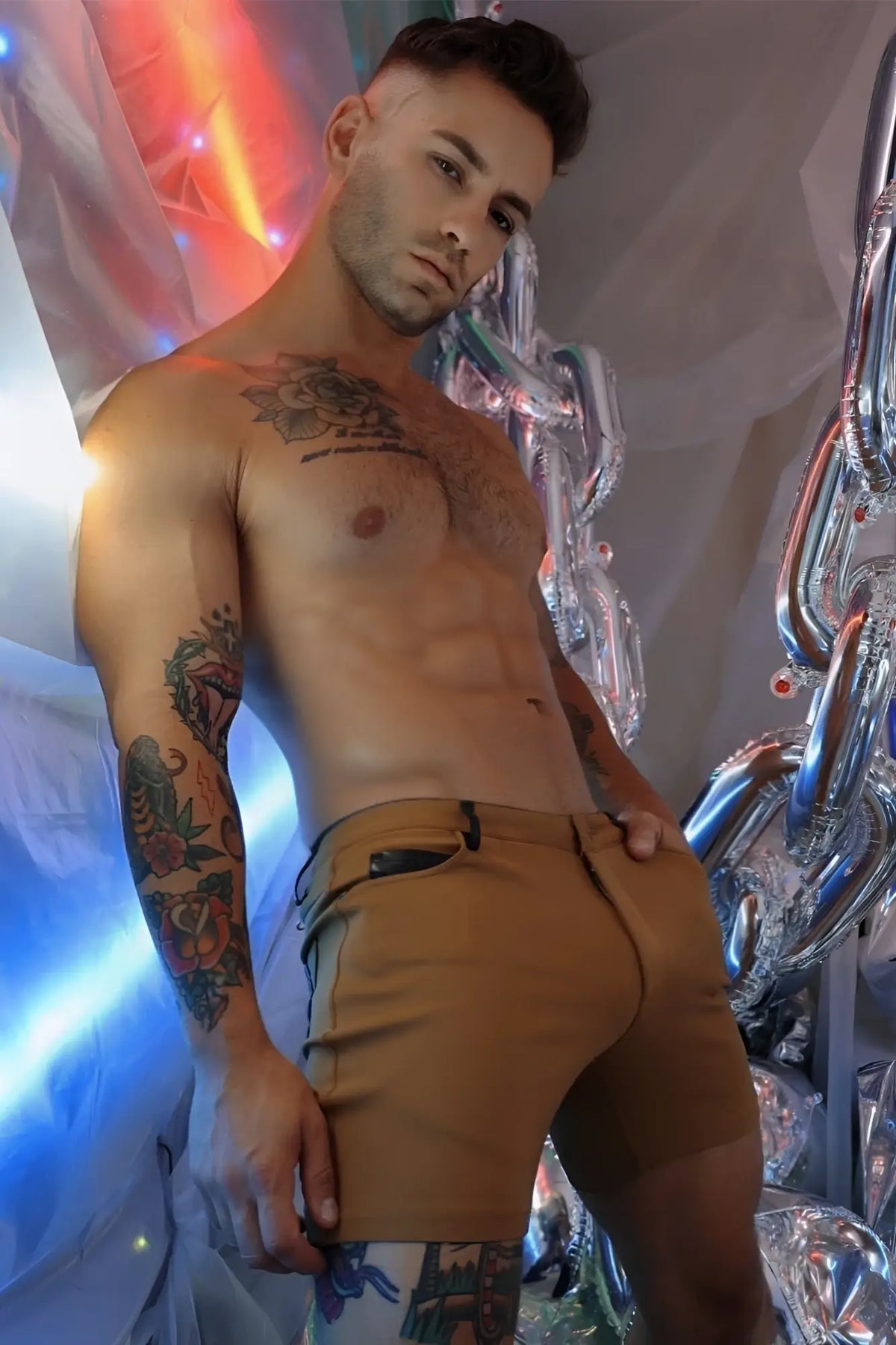 Tan down low shorts in dark khaki feature a zipper pocket on the right thigh and button closure for secure fit