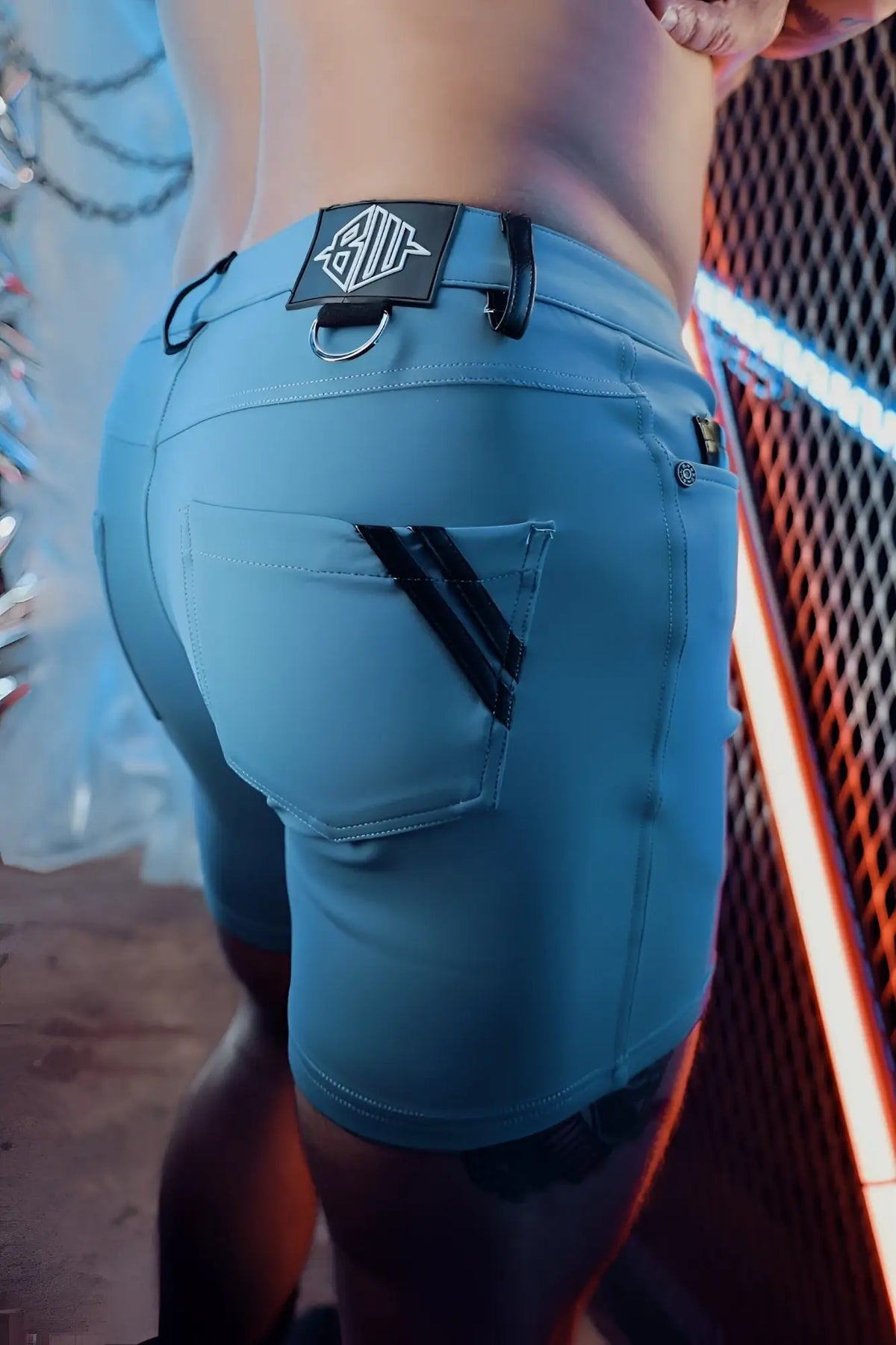 Light blue denim down low shorts with black trim and branded patch on the waistband in slate blue