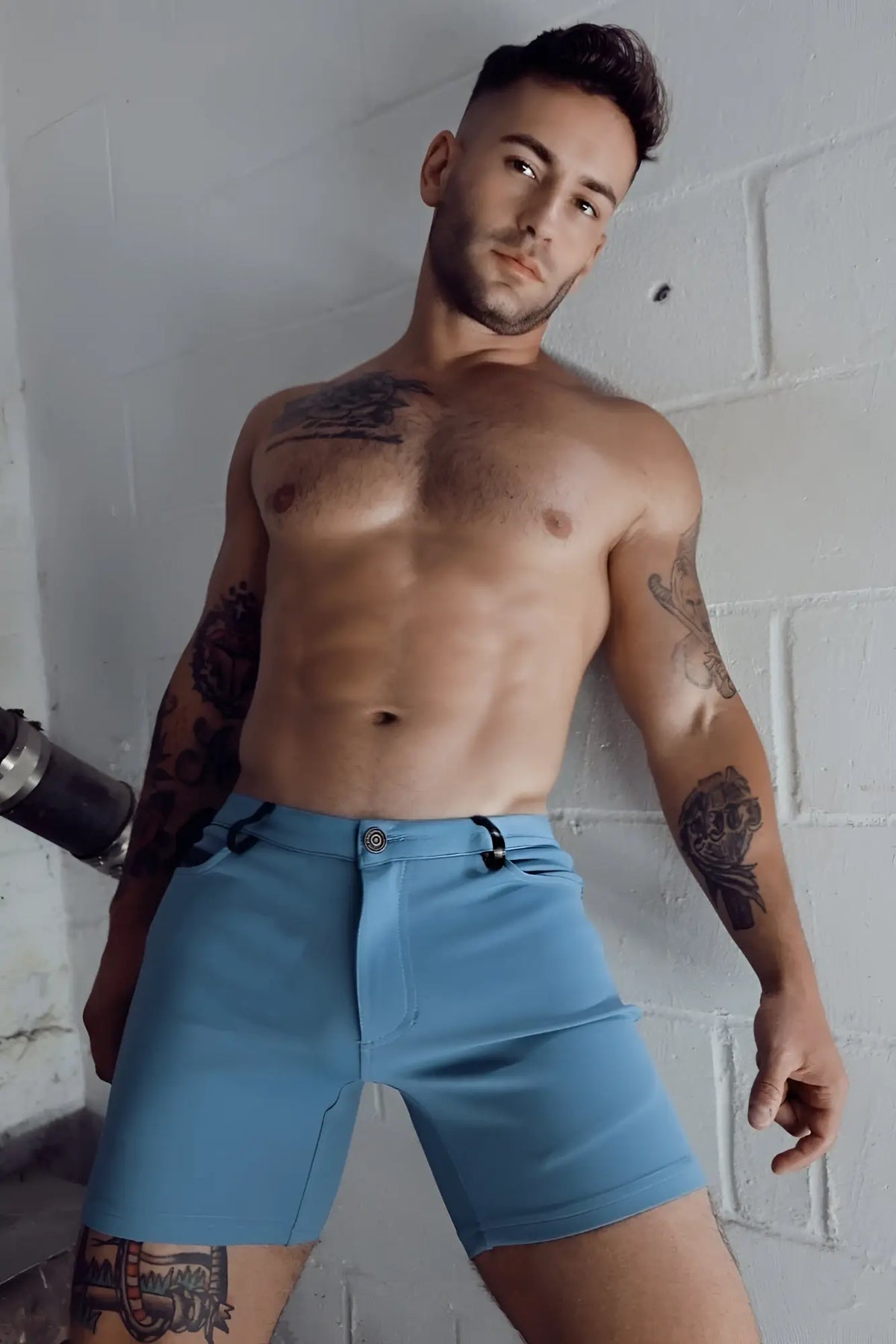 Light blue denim down low shorts with black belt loops and button closure in slate blue color