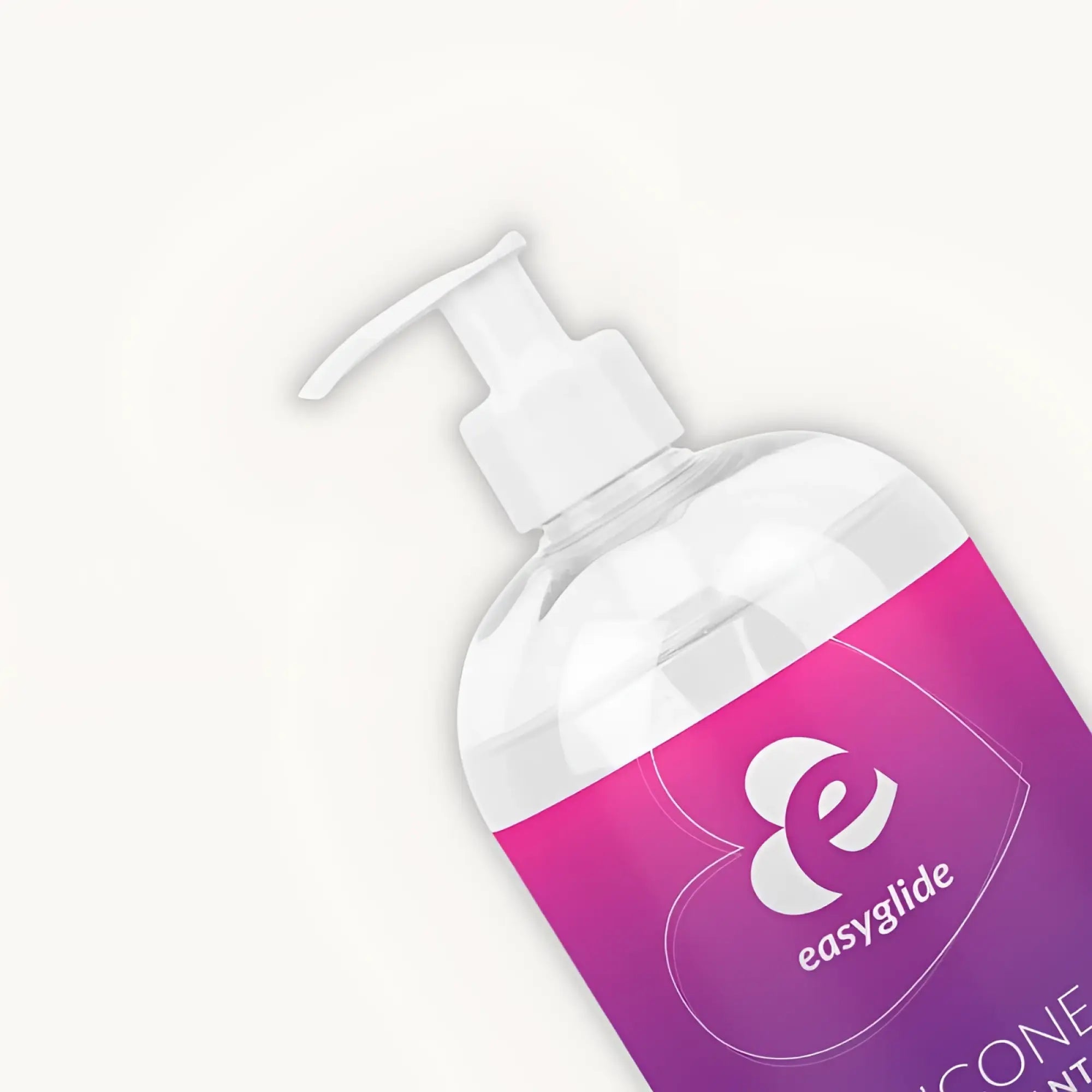 A clear plastic bottle with a white pump and pink to purple easyglide label containing silicone lubricant 1kg