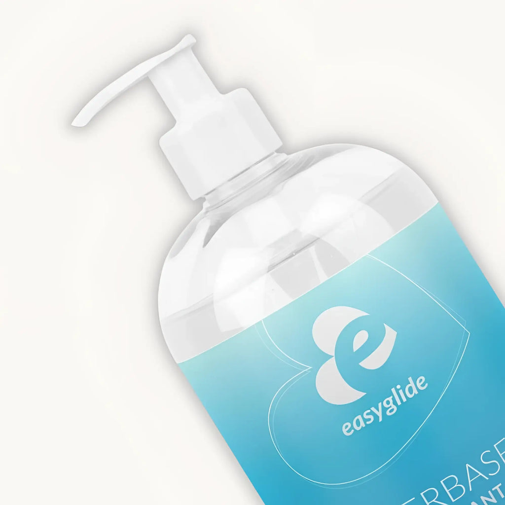 A clear plastic bottle with a white pump dispenser and a light blue easyglide label containing water based lubricant 1kg