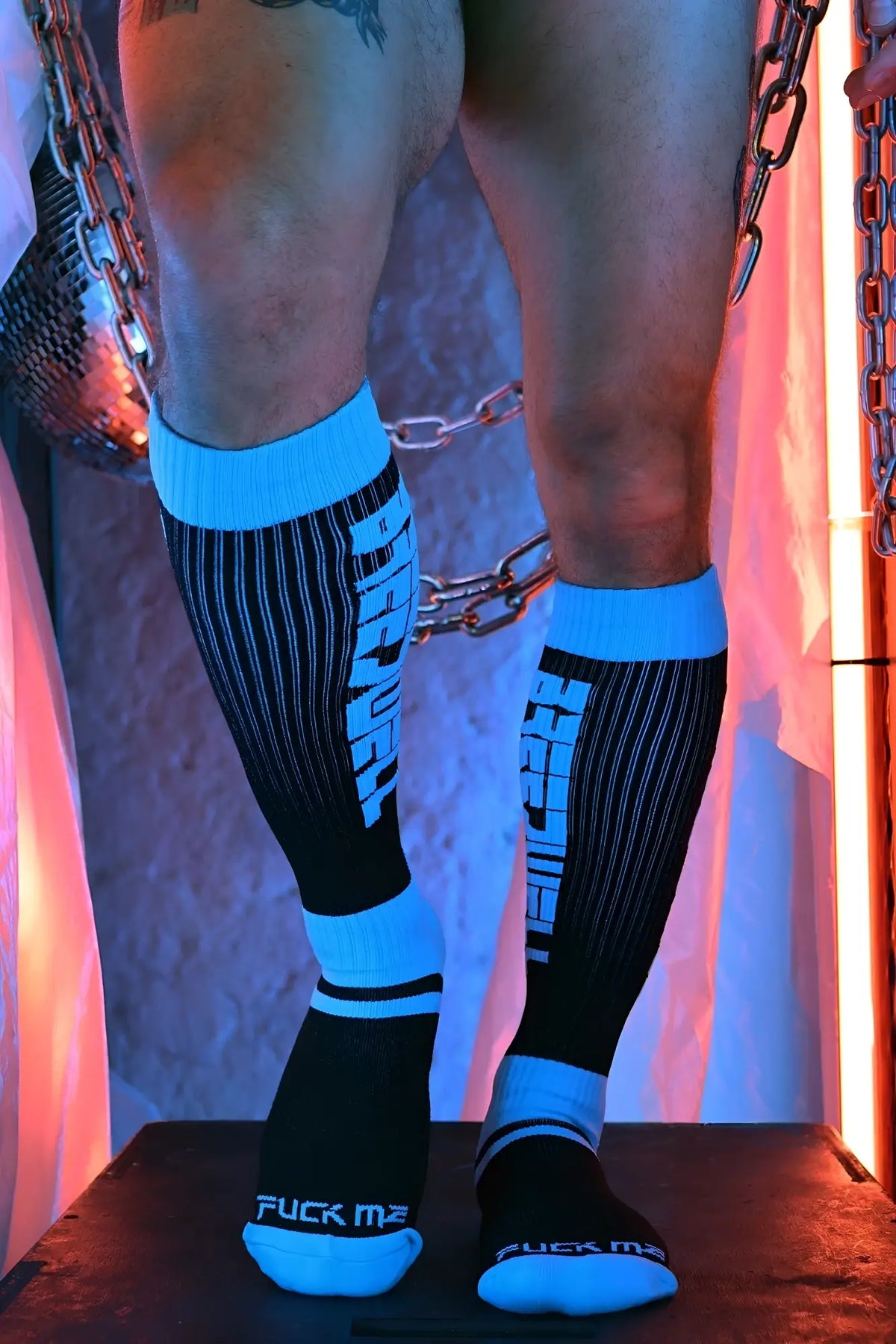 Eternity socks black and bright blue athletic knee-high socks with bold stripes and white text fuck me on sides