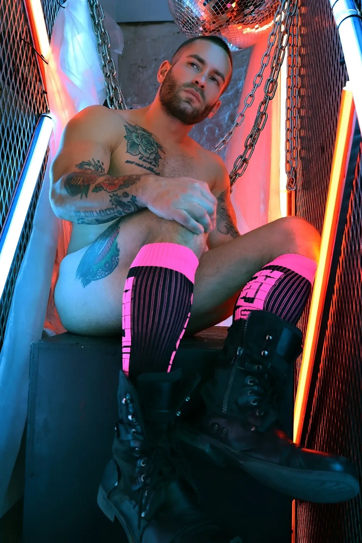 Black combat boots with neon pink accents and laces featured with eternity socks for edgy street style