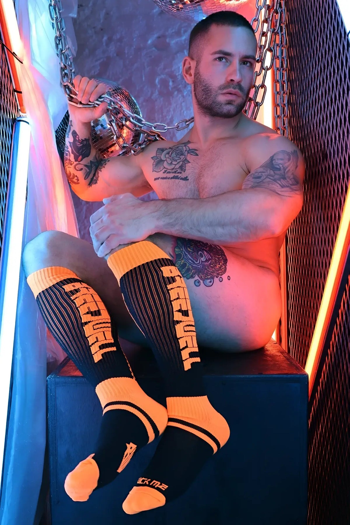 Eternity socks in black and neon orange featuring bold vertical lettering and ribbed cuff athletic design