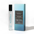 Clear glass rollerball perfume bottle with black cap and teal leaf logo labeled blue ember by pheromone cologne