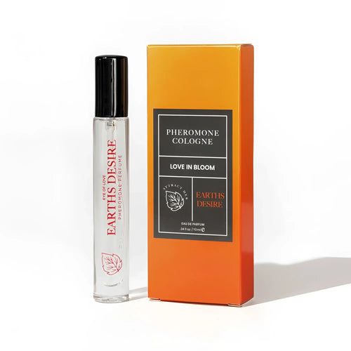 Clear glass rollerball pheromone body spray bottle with black cap and red text labeled earths desire love in bloom.