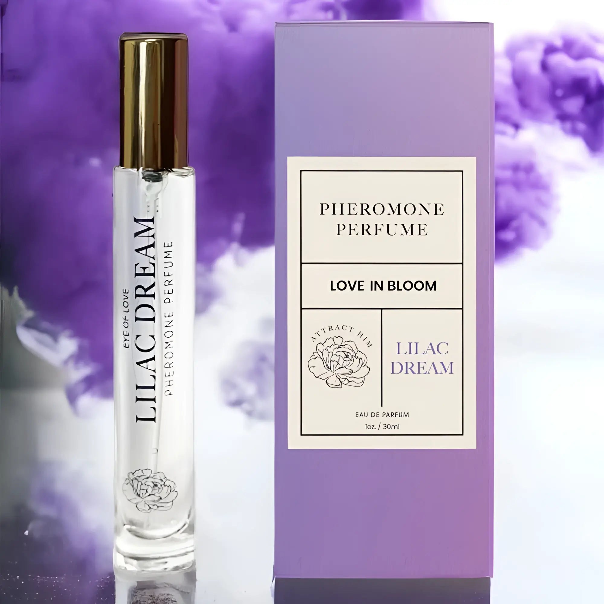 A clear glass rollerball perfume bottle with gold cap and lilac dream label beside its lavender pheromone perfume box