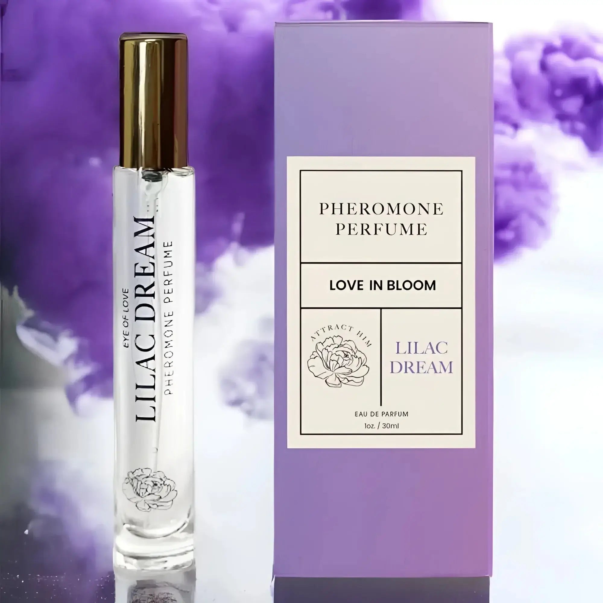 A clear glass rollerball perfume bottle with gold cap and lilac dream label beside its lavender pheromone perfume box