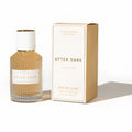 A golden hued ribbed glass bottle with white cap and gold accents beside its box for eye of love pheromone spray