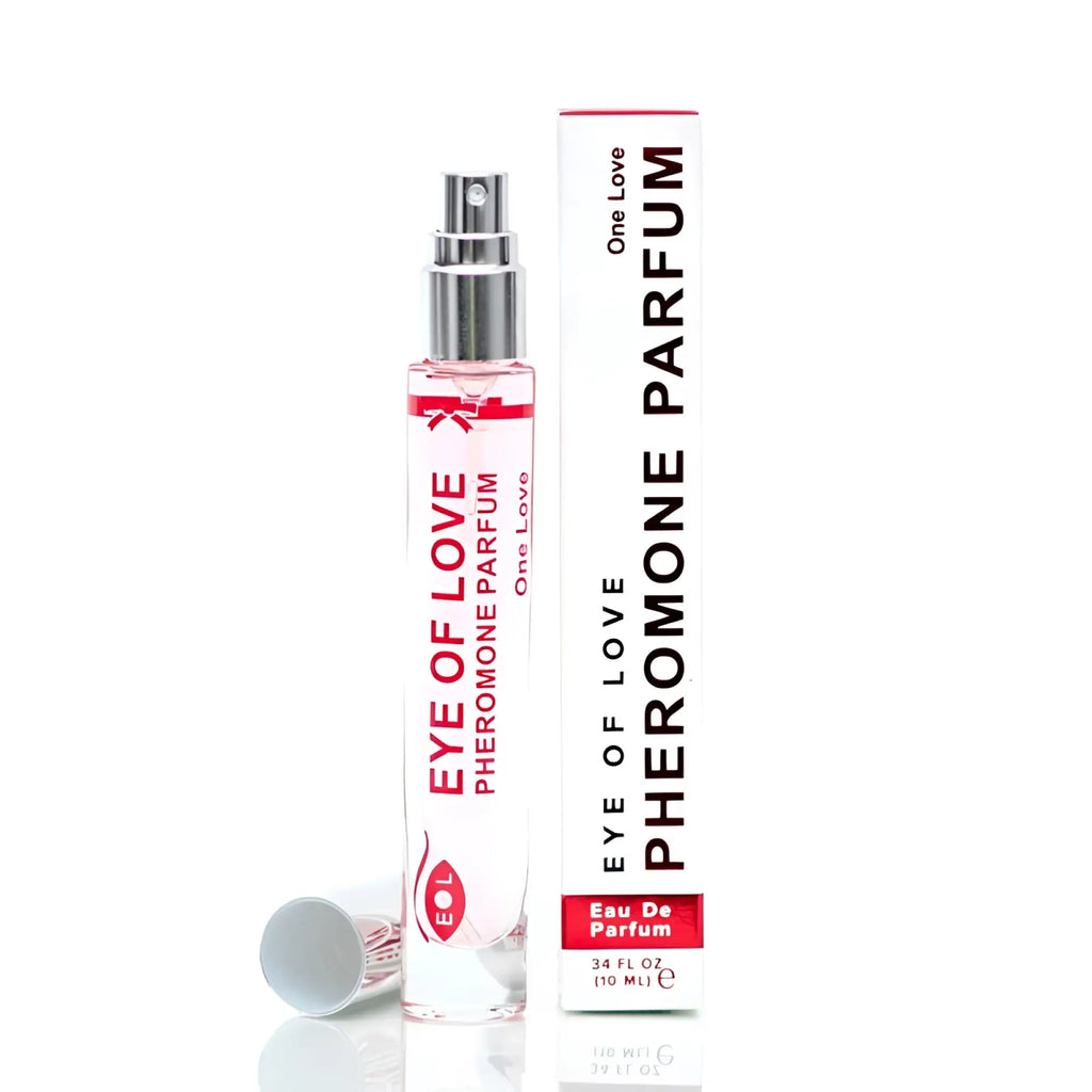 A clear glass spray bottle with silver nozzle and red eye of love pheromone perfume text beside its white box