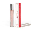A sleek transparent glass rollerball perfume bottle with silver cap and pink liquid labeled eye of love pheromone parfum next to red and white box