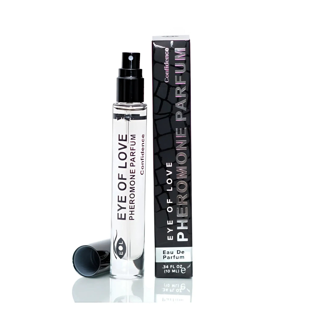 Clear glass spray bottle with black cap labeled eye of love pheromone parfum confidence beside matching black textured box