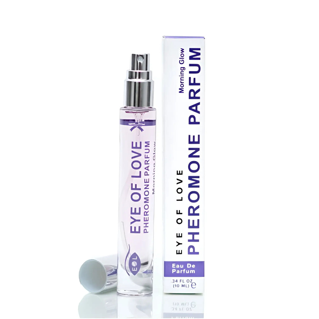 A sleek transparent glass bottle of eye of love pheromone body spray with silver nozzle and purple labeling