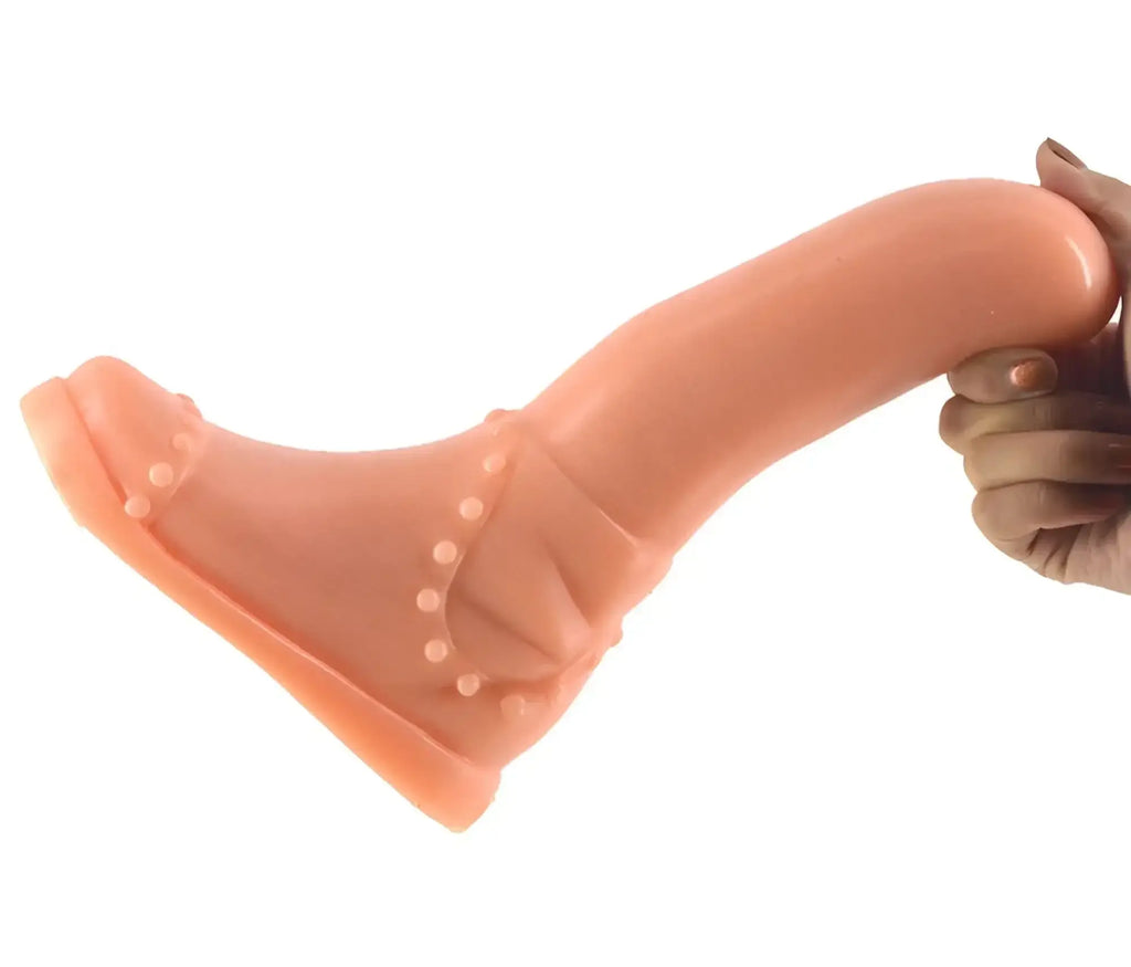 Peach-colored silicone boot-shaped dildo with decorative bead accents from FAAK Boot Dildo Flesh collection