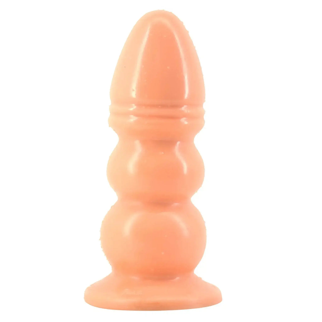 Peach-colored silicone anal plug faak huge anal plug flesh with rounded segmented design and flared base