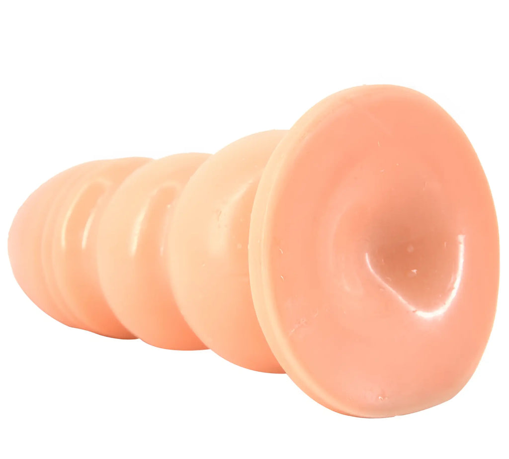 Peach-colored silicone suction cup anal plug with tapered segmented design from FAAK huge anal plug flesh