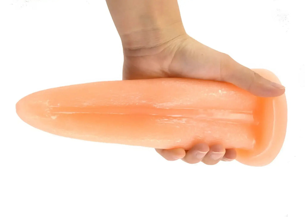 Peach-colored faak tongue shape anal plug made of smooth glossy silicone with tapered design for comfortable use