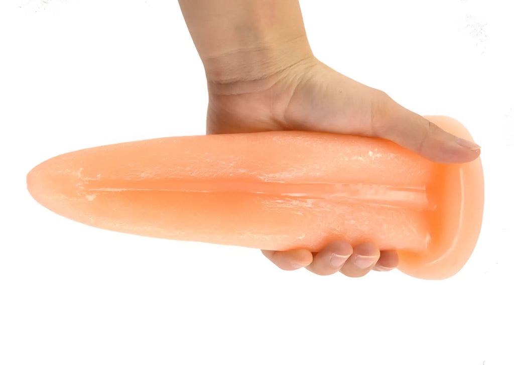 Peach-colored faak tongue shape anal plug made of smooth glossy silicone with tapered design for comfortable use